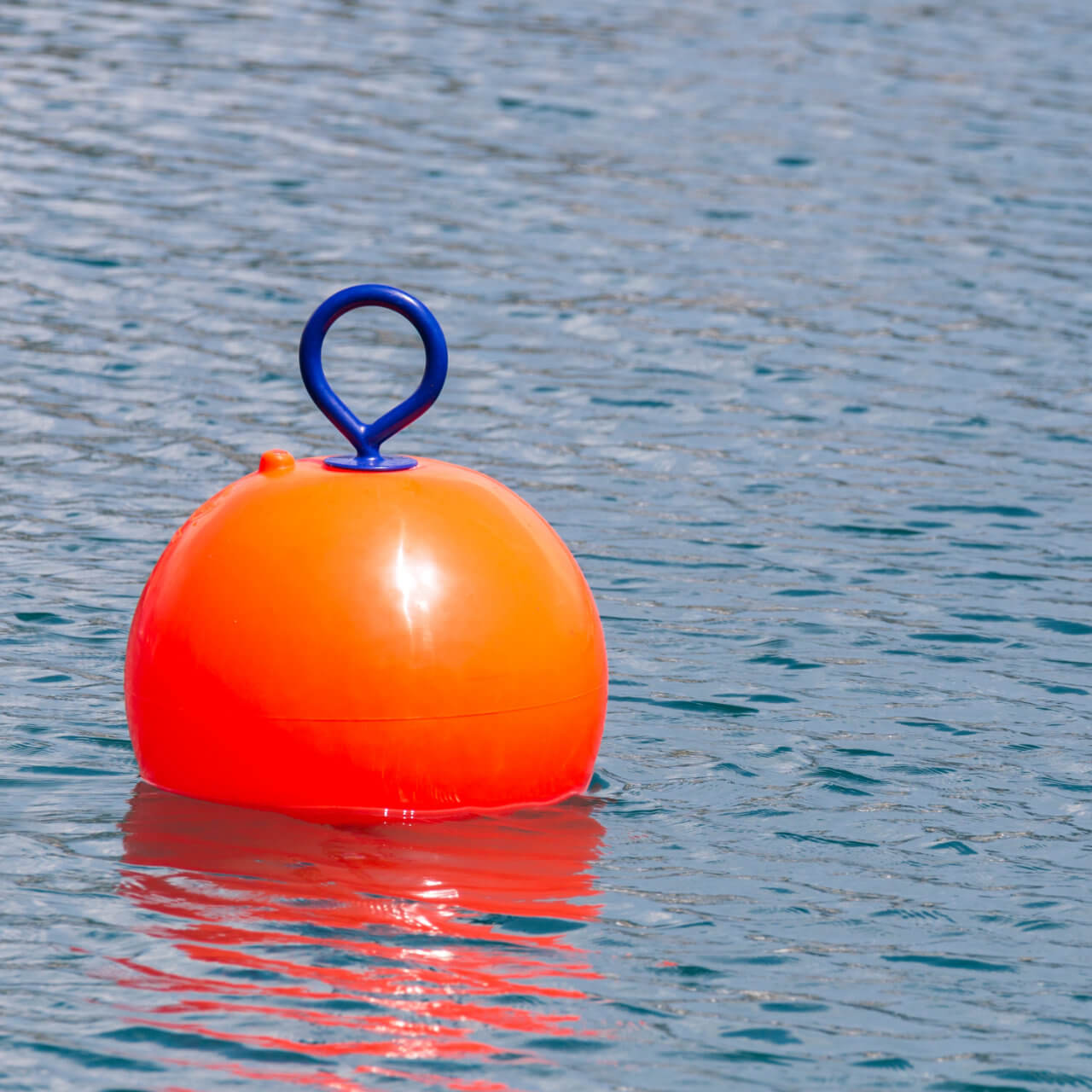 Red buoy for safety swimming in water